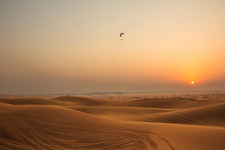 Experience the magic of Dubai's desert as the sun sets over rolling dunes setting the perfect stage for an unforgettable evening filled with cultural delights and desert adventures.